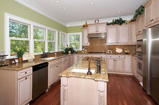 Design 42048. A kitchen with a view. Extra storage in the enlarged island compensates for the loss of cabinets on the outside wall. Lots of windows allow for tons of natural light!
